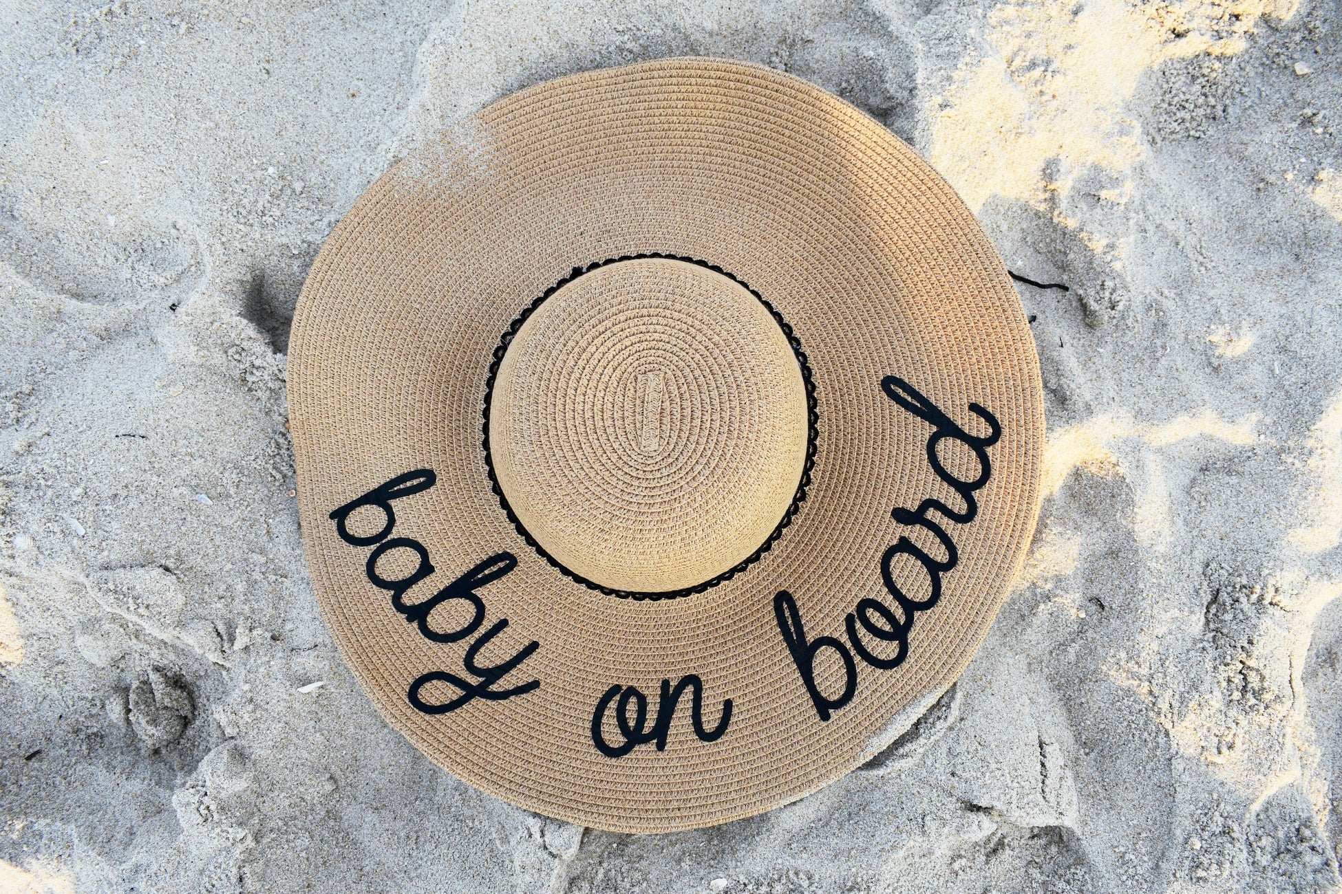 Hat with "baby on board" written on it