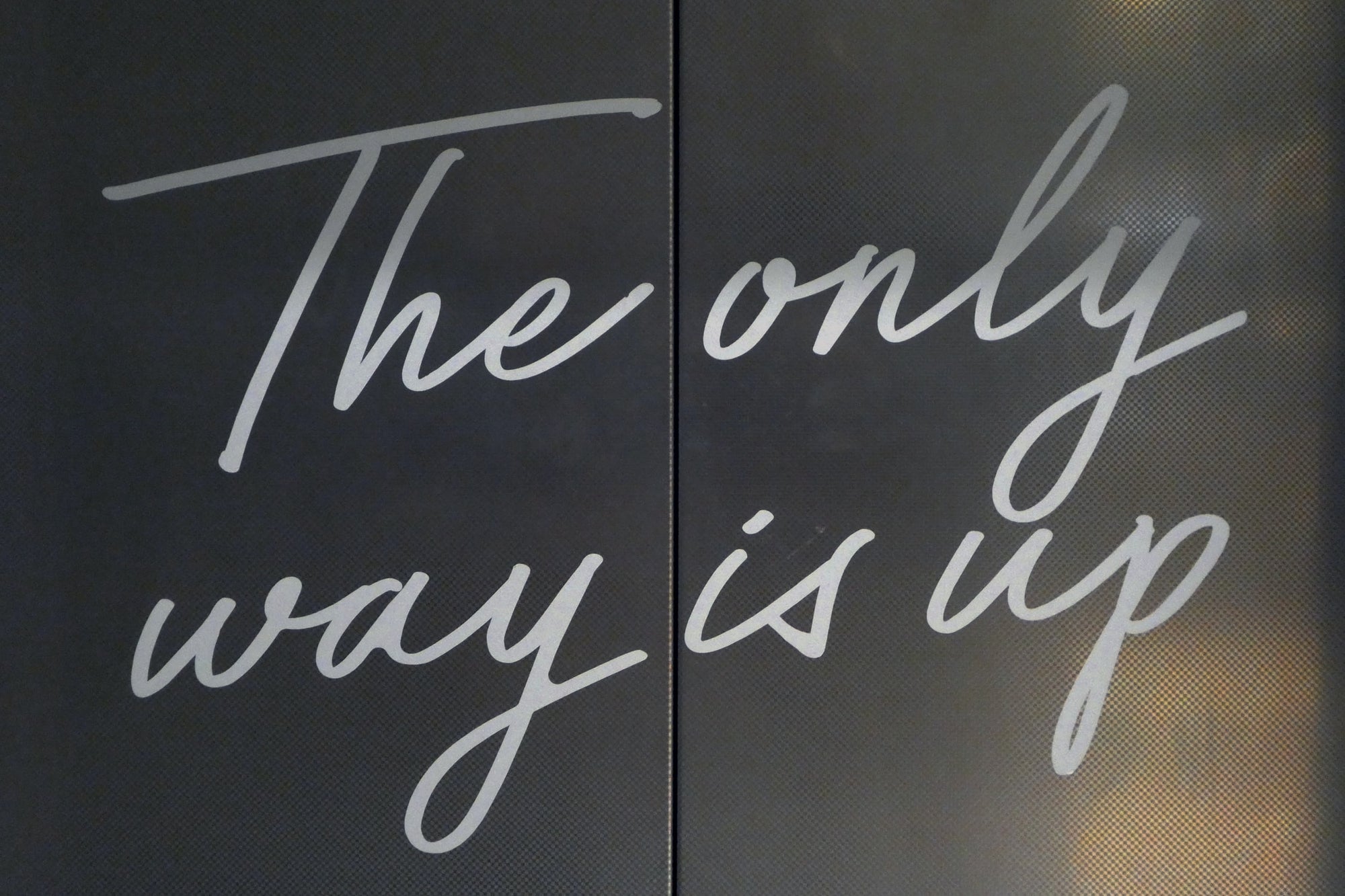Sign with "the only way is up" written on it