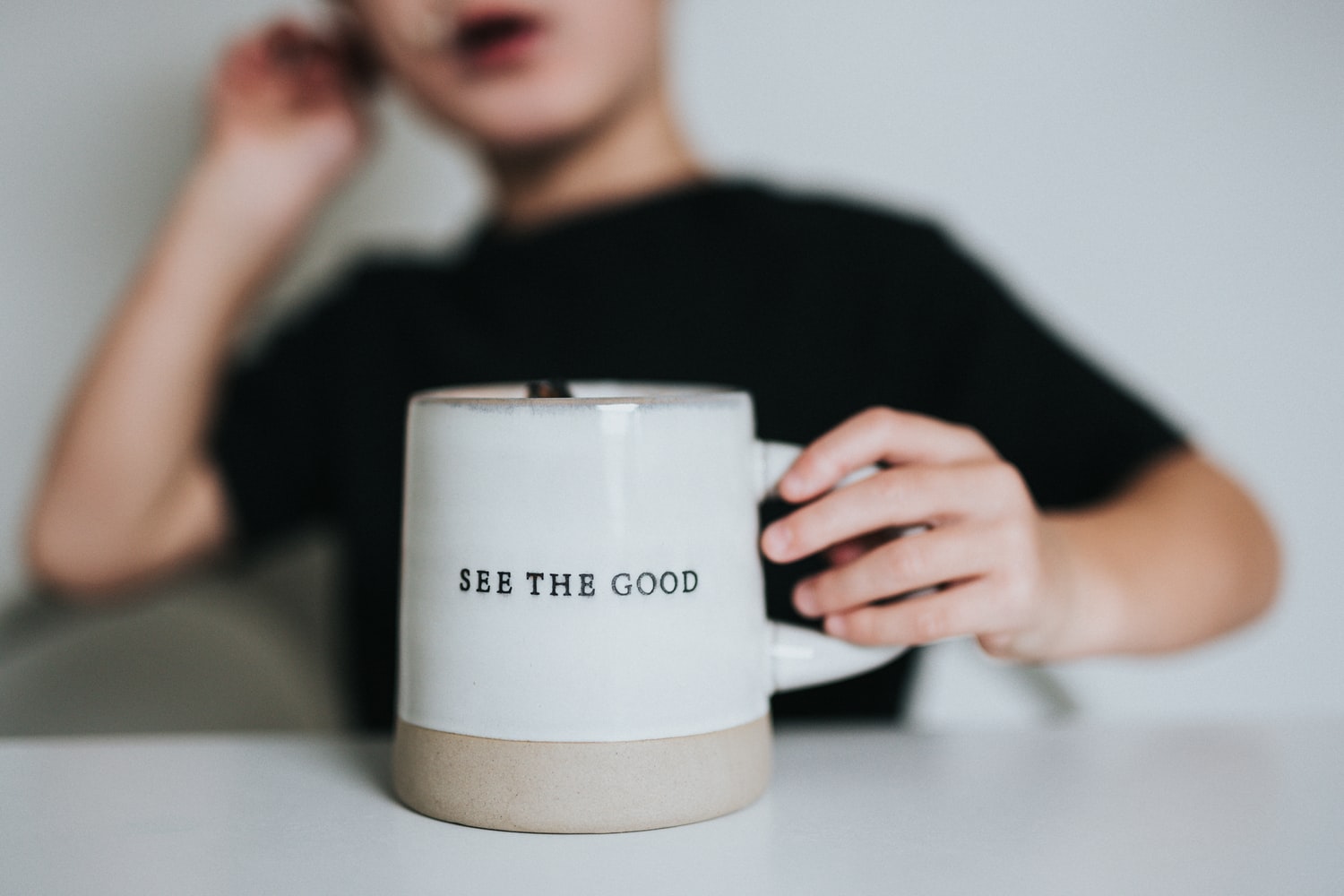 A mug which says "see the good"